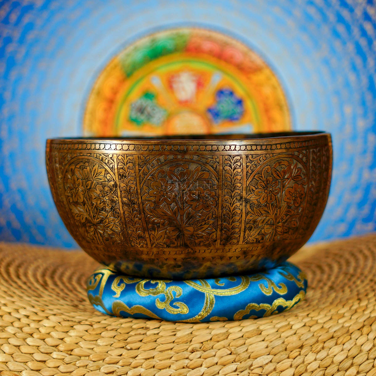 Semi antique handmade singing bowl with intricate floral panel engraving and aged bronze finish from Nepal
