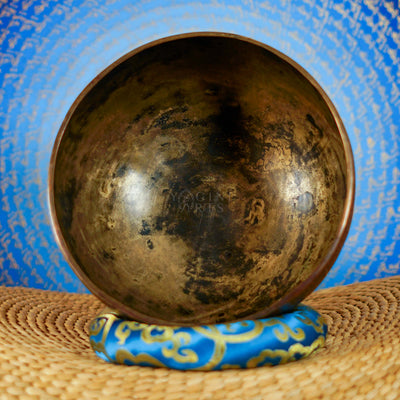 Semi antique handmade singing bowl with intricate floral panel engraving and aged bronze finish from Nepal