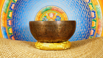 Semi antique handmade singing bowl with intricate flower vase engraving and floral patterns on aged bronze