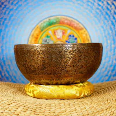 Semi antique handmade singing bowl with intricate flower vase engraving and floral patterns on aged bronze