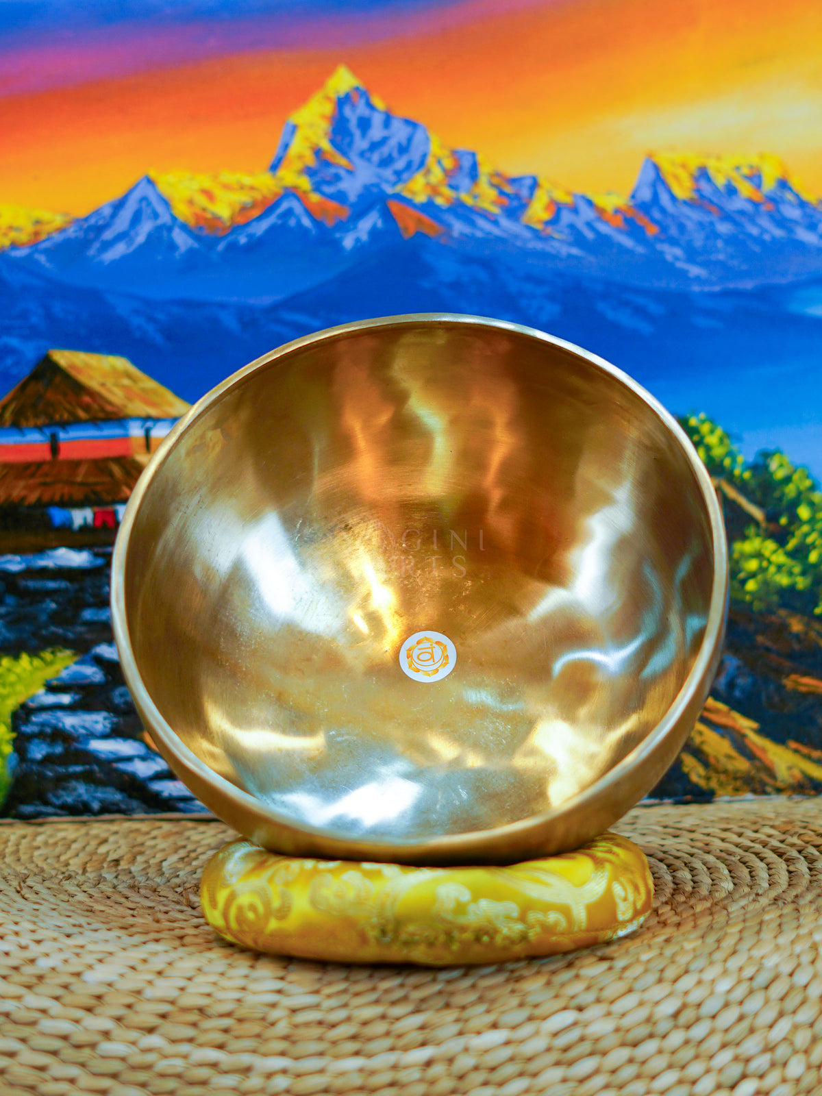 Seven handcrafted Himalayan singing bowls arranged together, showing graduated sizes, chakra symbols, and warm antique bronze-gold finishes.
