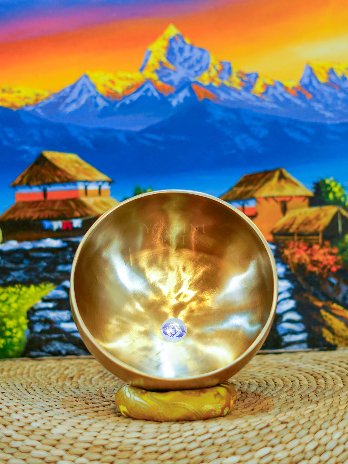 Seven handcrafted Himalayan singing bowls arranged together, showing graduated sizes, chakra symbols, and warm antique bronze-gold finishes.