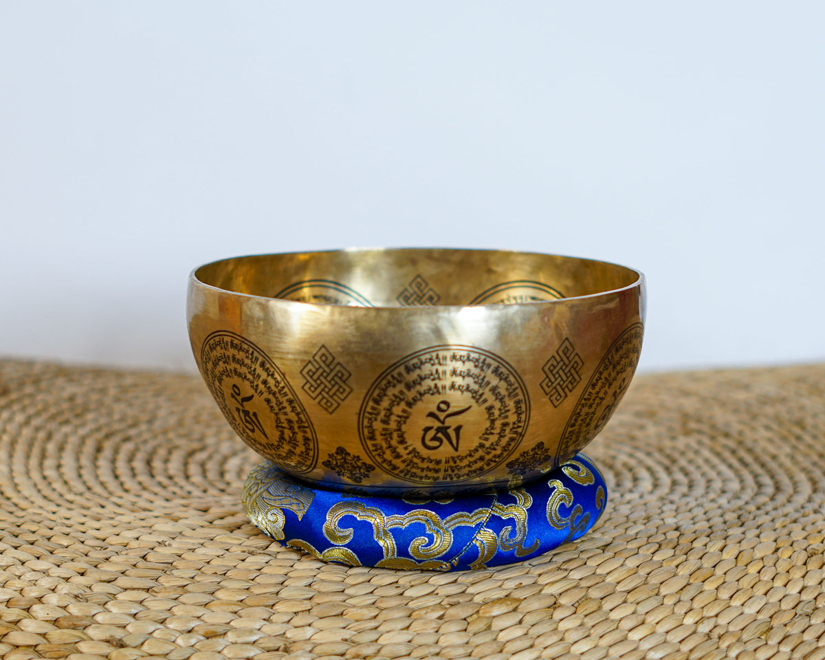 Medicine Buddha singing bowl with detailed central engraving and Tibetan Buddhist mantras