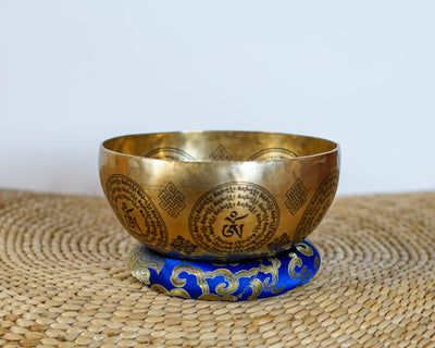 Medicine Buddha singing bowl with detailed central engraving and Tibetan Buddhist mantras