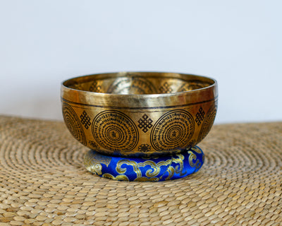 Medicine Buddha mantra singing bowl with circular Tibetan inscriptions and auspicious symbols