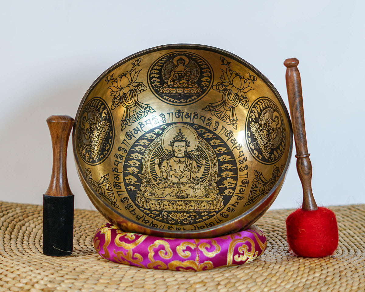 Interior view of Chengresi singing bowl showing the four armed Bodhisattva, lotus throne, Tibetan inscriptions, and decorative motifs