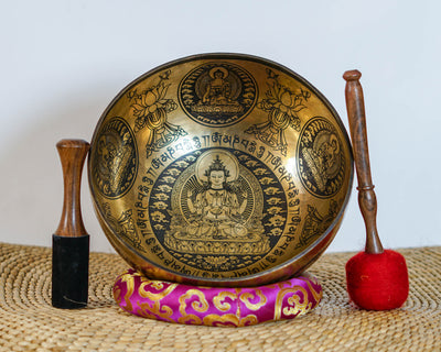 Interior view of Chengresi singing bowl showing the four armed Bodhisattva, lotus throne, Tibetan inscriptions, and decorative motifs