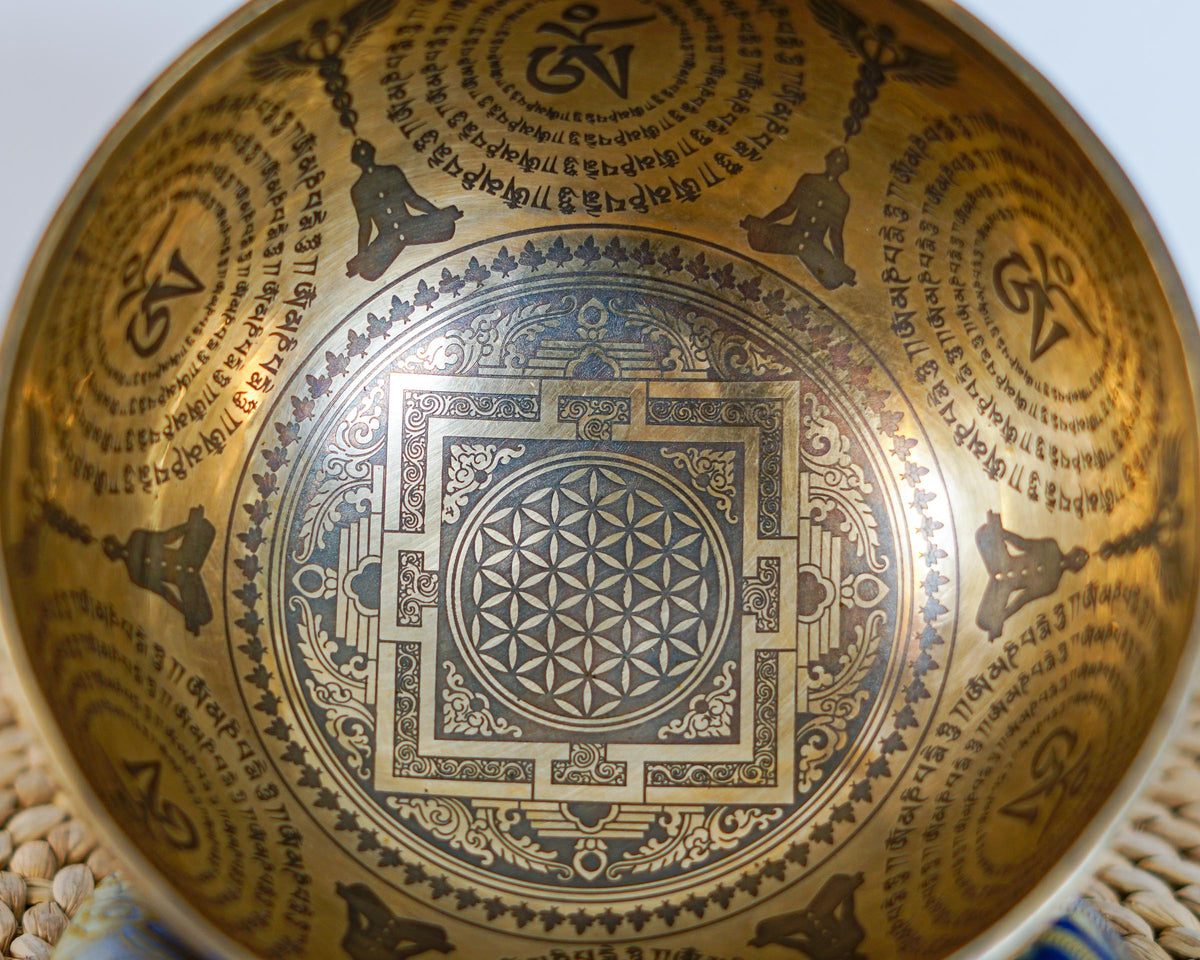 Close up of the geometric mandala and traditional Tibetan mantra engravings inside the singing bowl.