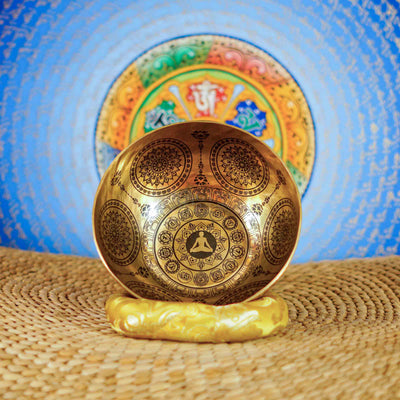 Chakra Mandala singing bowl with sacred geometry, meditation figure, and detailed engraved Buddhist-inspired artwork