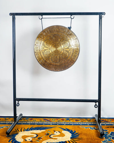 Close-up of a handmade Tibetan-style gong featuring a Flower of Life-inspired center, lotus mandala and intricate floral engraving.