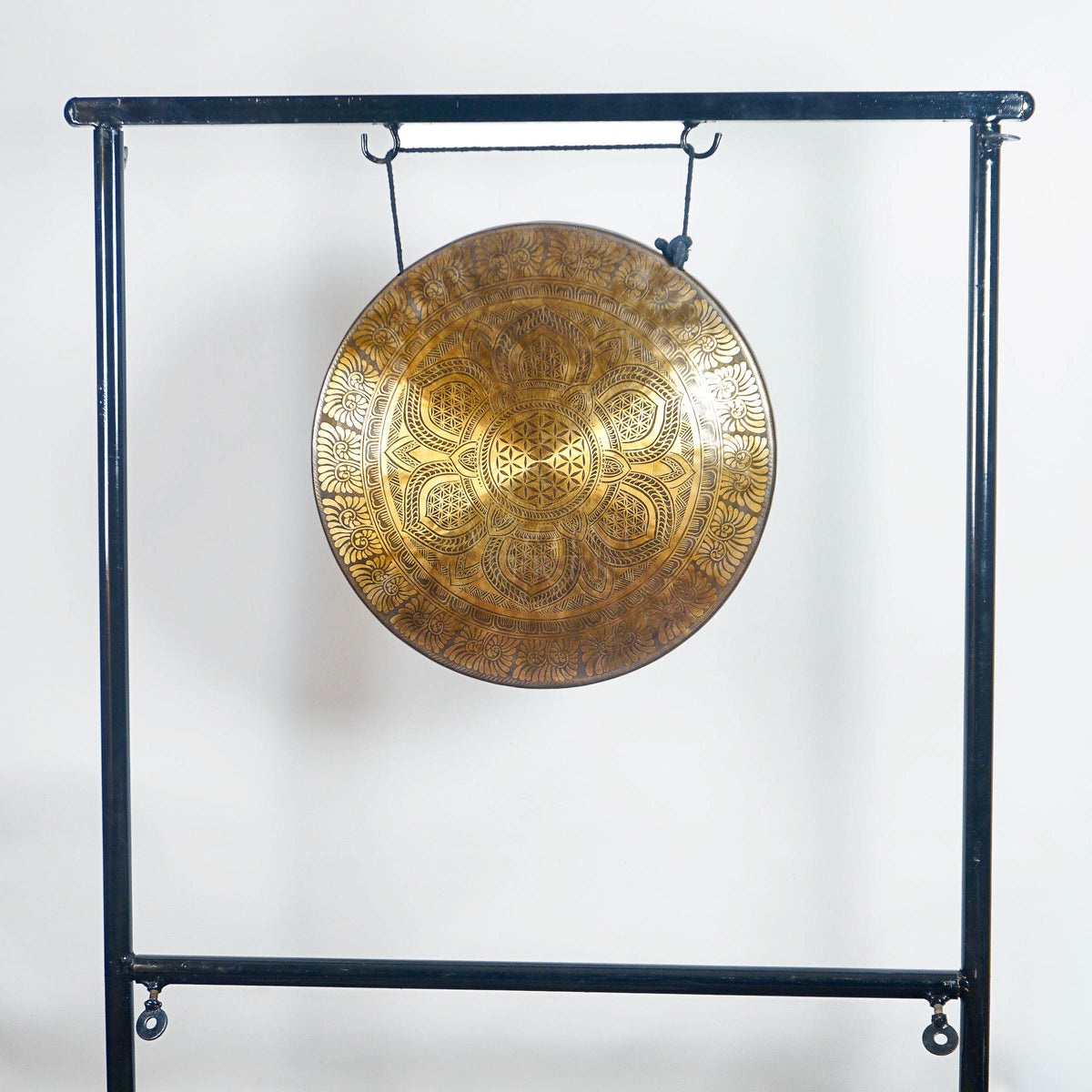 Full view of a handmade bronze Tibetan-style gong with lotus mandala and Flower of Life-inspired design on a black metal stand.