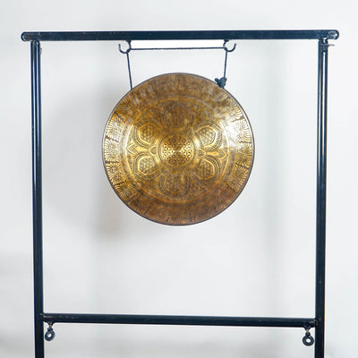 Full view of a handmade bronze Tibetan-style gong with lotus mandala and Flower of Life-inspired design on a black metal stand.