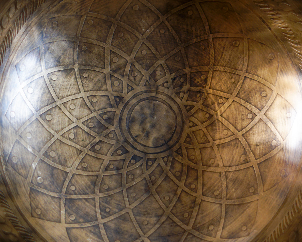 Close up of the concentric cosmic geometric engraving inside an antique bronze Tibetan singing bowl.