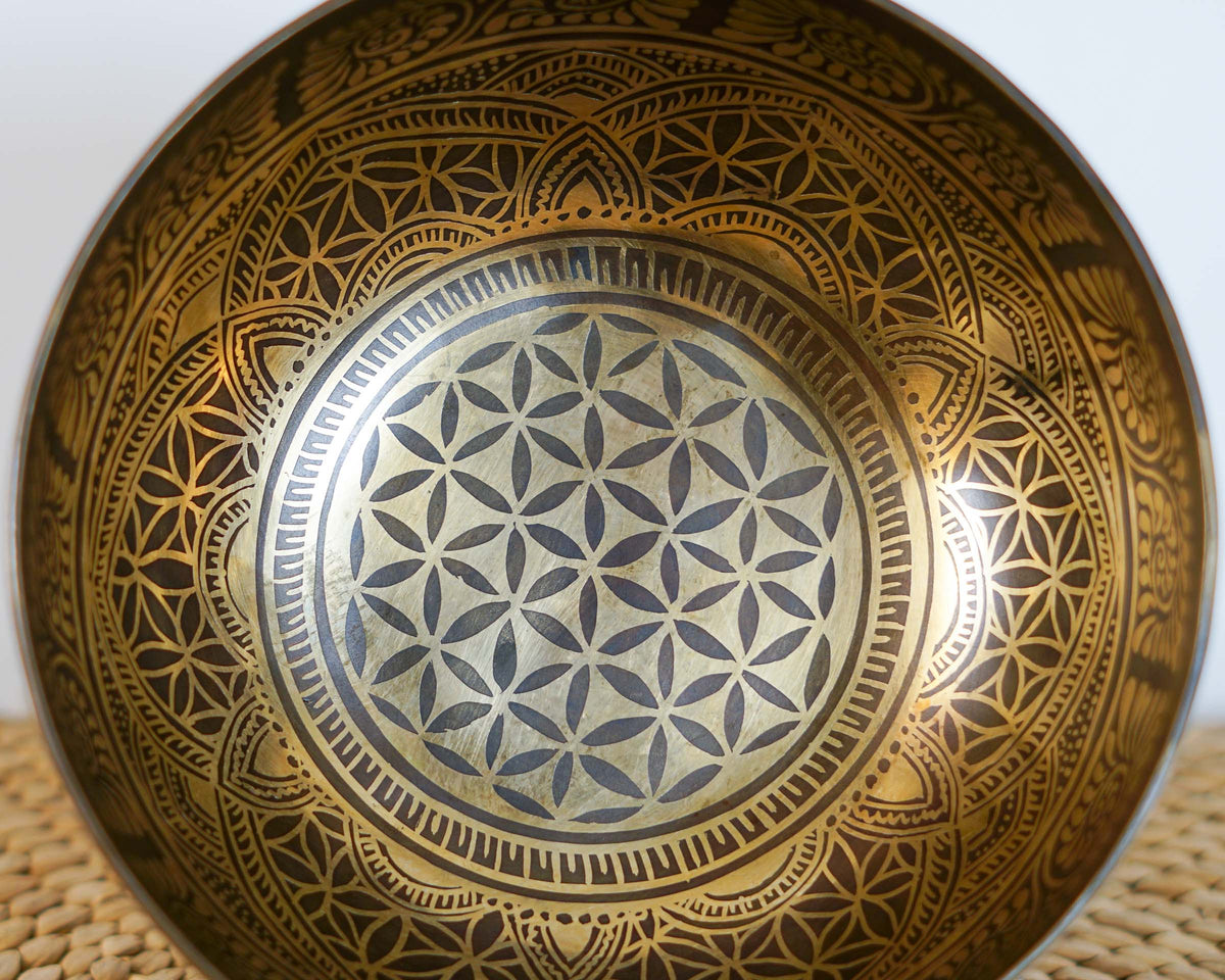 Close up of the Flower of Life sacred geometry engraved inside a golden Tibetan singing bowl.