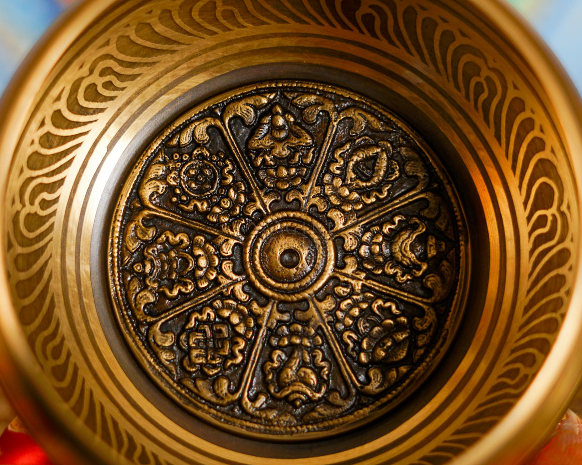 Close-up of auspicious singing bowl showing detailed traditional symbolic design