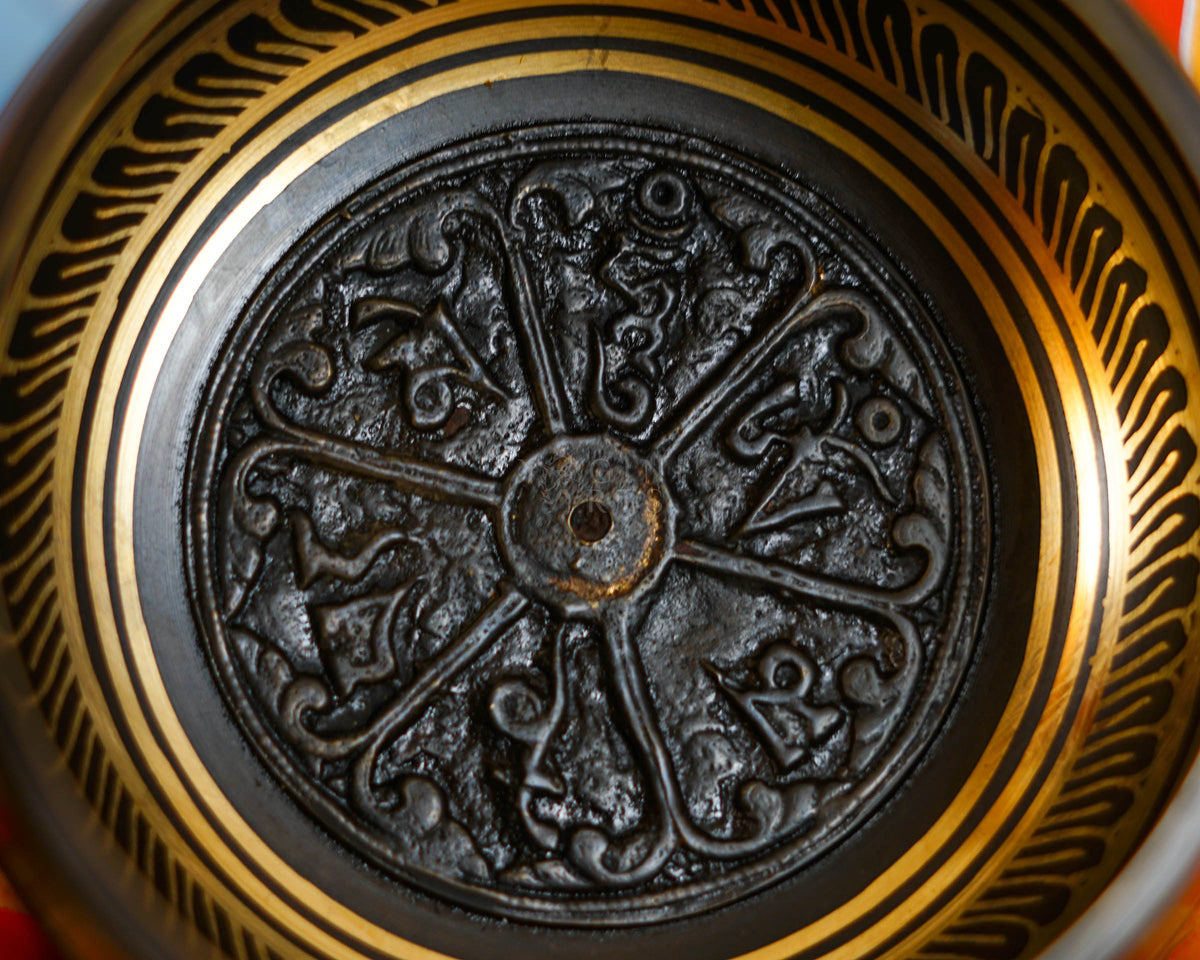 Close-up of sacred mantra design inside a handcrafted Himalayan singing bowl