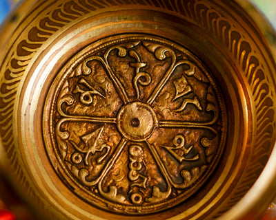 Close-up of intricate mantra design inside a traditional Himalayan singing bowl