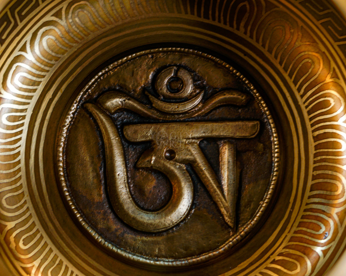 Close-up of sacred mantra design inside handcrafted Himalayan singing bowl