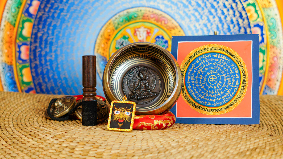 Handcrafted Green Tara bronze singing bowl with raised Buddhist figure and engraved interior