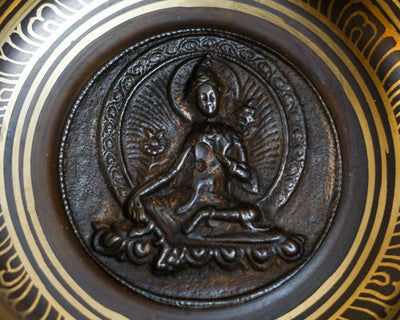 Close-up of Green Tara relief inside a handcrafted bronze singing bowl from Nepal