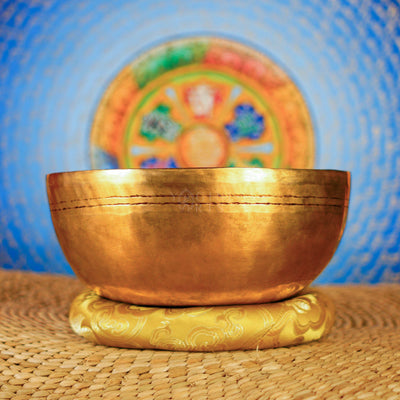 Side view of handcrafted Mahakala singing bowl with antique golden finish