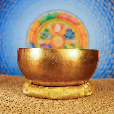 Side view of handcrafted Medicine Buddha singing bowl with golden finish from Nepal