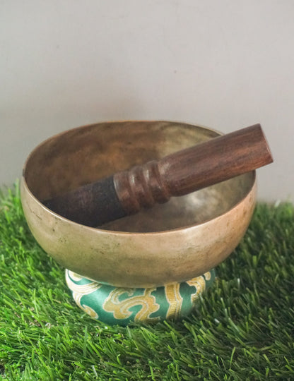Semi-antique Tibetan singing bowl handcrafted in Nepal with aged patina.