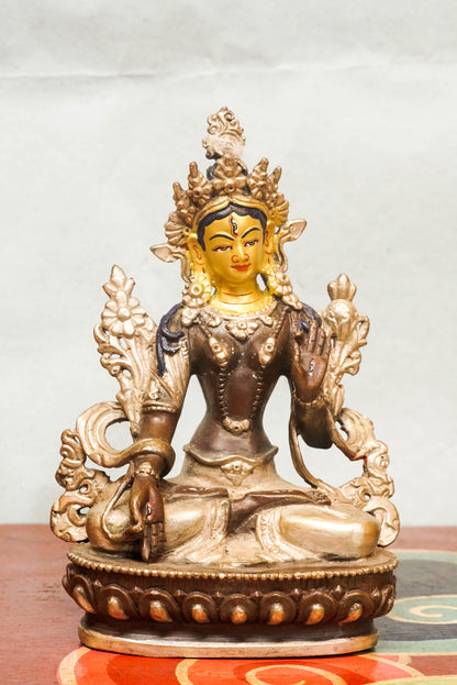 White Tara statue, a symbol of healing, compassion. With seven all-seeing eyes and serene lotus posture, she brings peaceful energy and protection.