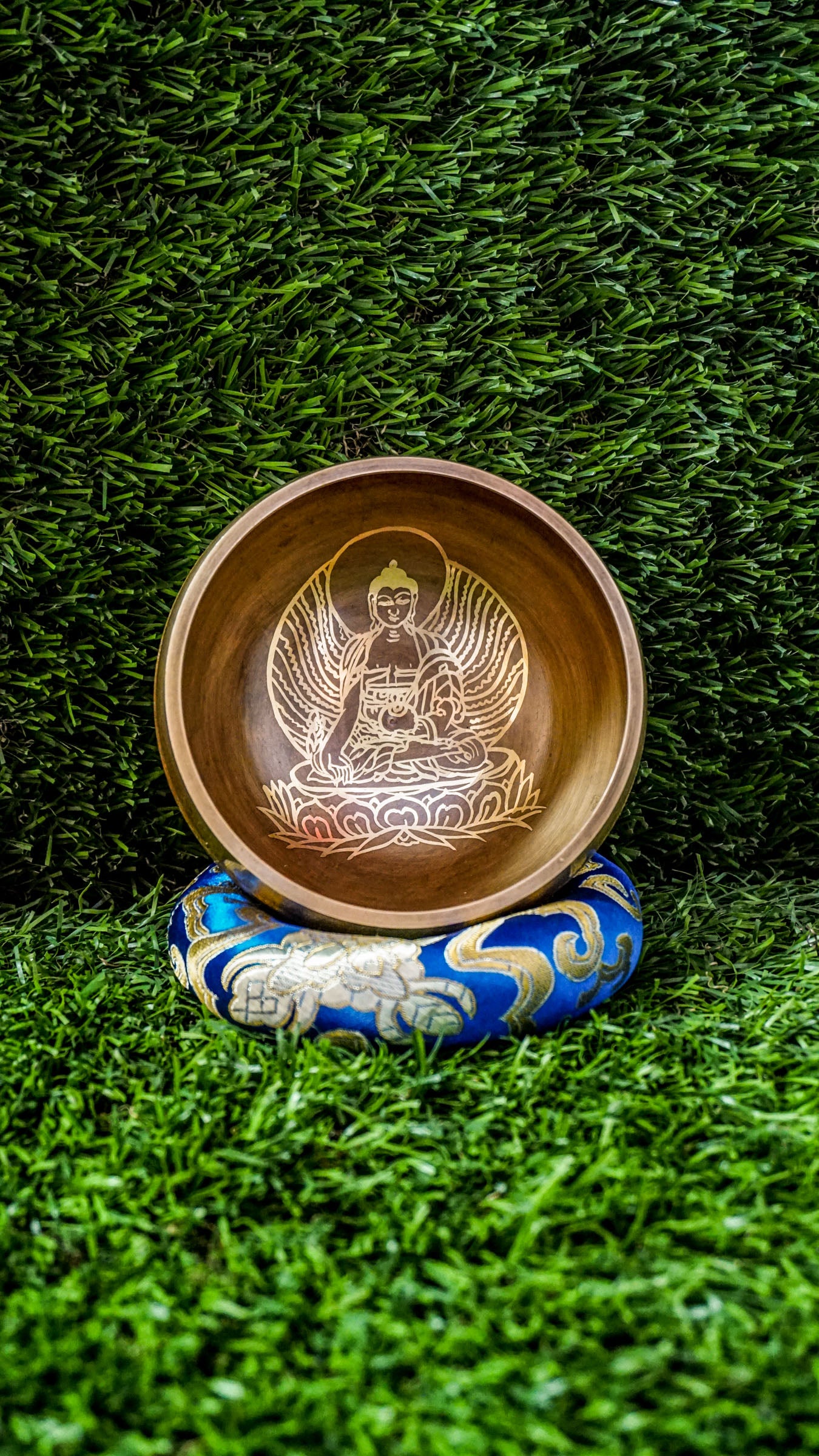 The Buddha Singing Bowl is a gentle reminder to return to stillness and presence. At its center, a peaceful image of the Buddha in meditation invites you to slow down, breathe, and reconnect with your inner calm. His seated posture speaks of balance, mindfulness, and the quiet power of awareness.&nbsp;Surrounding the outer edge of the bowl is the sacred mantra Om Mani Padme Hum. This ancient chant carries a peaceful vibration, supporting your journey toward clarity, compassion, and emotional grounding. 
