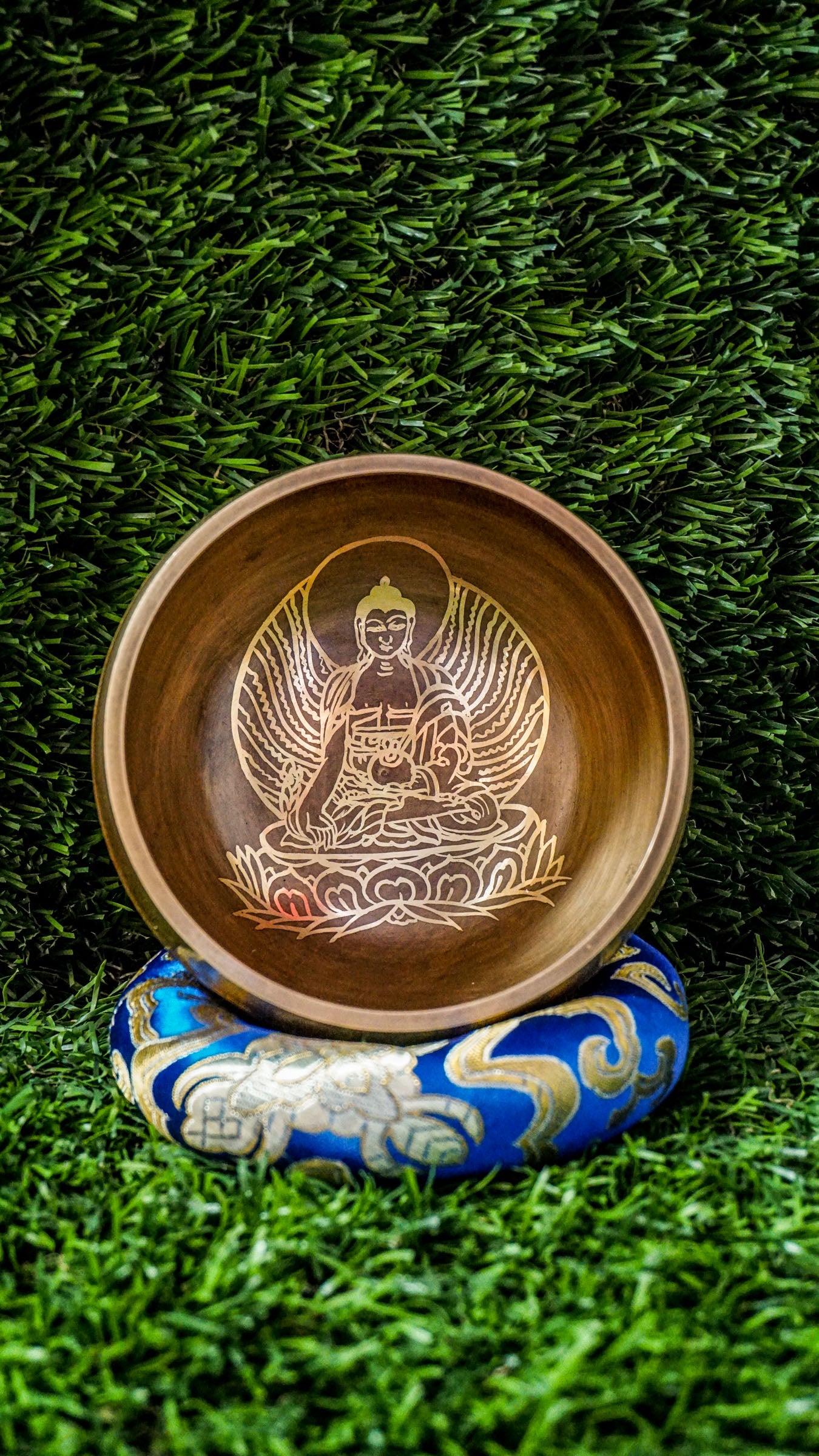 The Buddha Singing Bowl is a gentle reminder to return to stillness and presence. At its center, a peaceful image of the Buddha in meditation invites you to slow down, breathe, and reconnect with your inner calm. His seated posture speaks of balance, mindfulness, and the quiet power of awareness.&nbsp;Surrounding the outer edge of the bowl is the sacred mantra Om Mani Padme Hum. This ancient chant carries a peaceful vibration, supporting your journey toward clarity, compassion, and emotional grounding. 