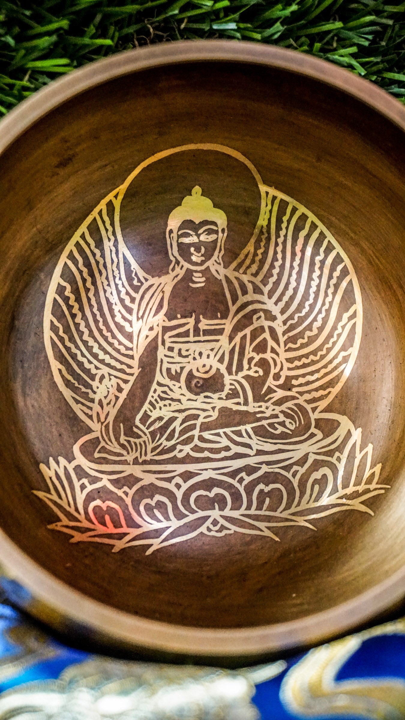 The Buddha Singing Bowl is a gentle reminder to return to stillness and presence. At its center, a peaceful image of the Buddha in meditation invites you to slow down, breathe, and reconnect with your inner calm. His seated posture speaks of balance, mindfulness, and the quiet power of awareness.&nbsp;Surrounding the outer edge of the bowl is the sacred mantra Om Mani Padme Hum. This ancient chant carries a peaceful vibration, supporting your journey toward clarity, compassion, and emotional grounding. 
