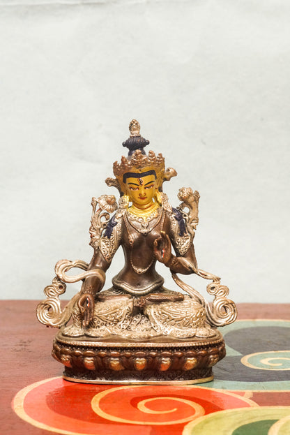 The silver-covered White Tara statue, she sits in serene lotus posture with seven eyes symbolizing watchful wisdom. A radiant symbol of peace and longevity, meditation, or as a meaningful spiritual gift.