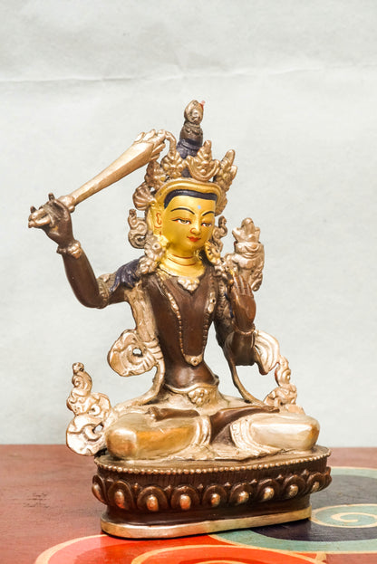Manjushri statue is known as the Bodhisattva of Wisdom, Manjushri holds a flaming sword to cut through ignorance and a lotus supporting sacred scriptures. It is perfect for meditation spaces, study areas, or altars, it inspires insight, spiritual growth, and intellectual awakening.