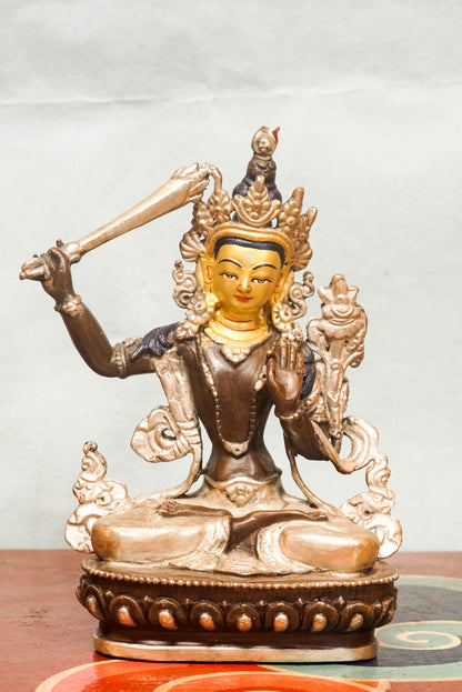 Manjushri statue is known as the Bodhisattva of Wisdom, Manjushri holds a flaming sword to cut through ignorance and a lotus supporting sacred scriptures. It is perfect for meditation spaces, study areas, or altars, it inspires insight, spiritual growth, and intellectual awakening.