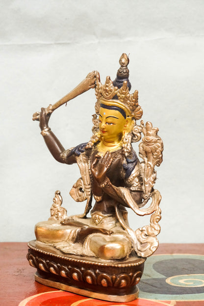 Manjushri statue is known as the Bodhisattva of Wisdom, Manjushri holds a flaming sword to cut through ignorance and a lotus supporting sacred scriptures. It is perfect for meditation spaces, study areas, or altars, it inspires insight, spiritual growth, and intellectual awakening.