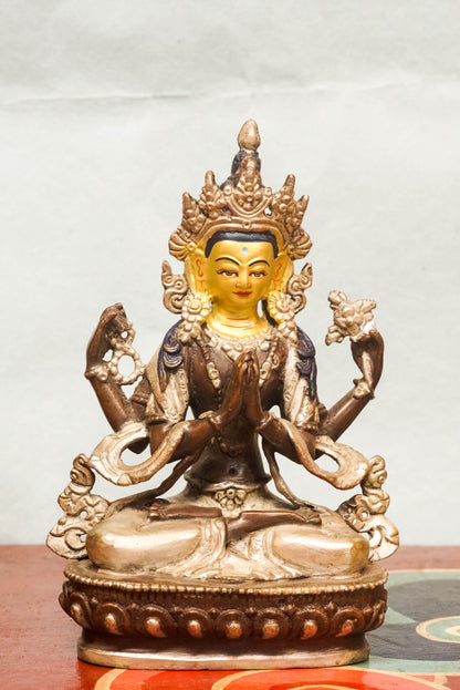 Chenrezig statue features a gold-painted face symbolizing wisdom and a silver-painted leg representing purity. Depicting the four-armed Bodhisattva of Compassion, it holds a lotus, prayer beads, and a wish-fulfilling jewel. It is meaningful symbol of compassion and purity.