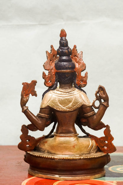 Chenrezig statue features a gold-painted face symbolizing wisdom and a silver-painted leg representing purity. Depicting the four-armed Bodhisattva of Compassion, it holds a lotus, prayer beads, and a wish-fulfilling jewel. It is meaningful symbol of compassion and purity.