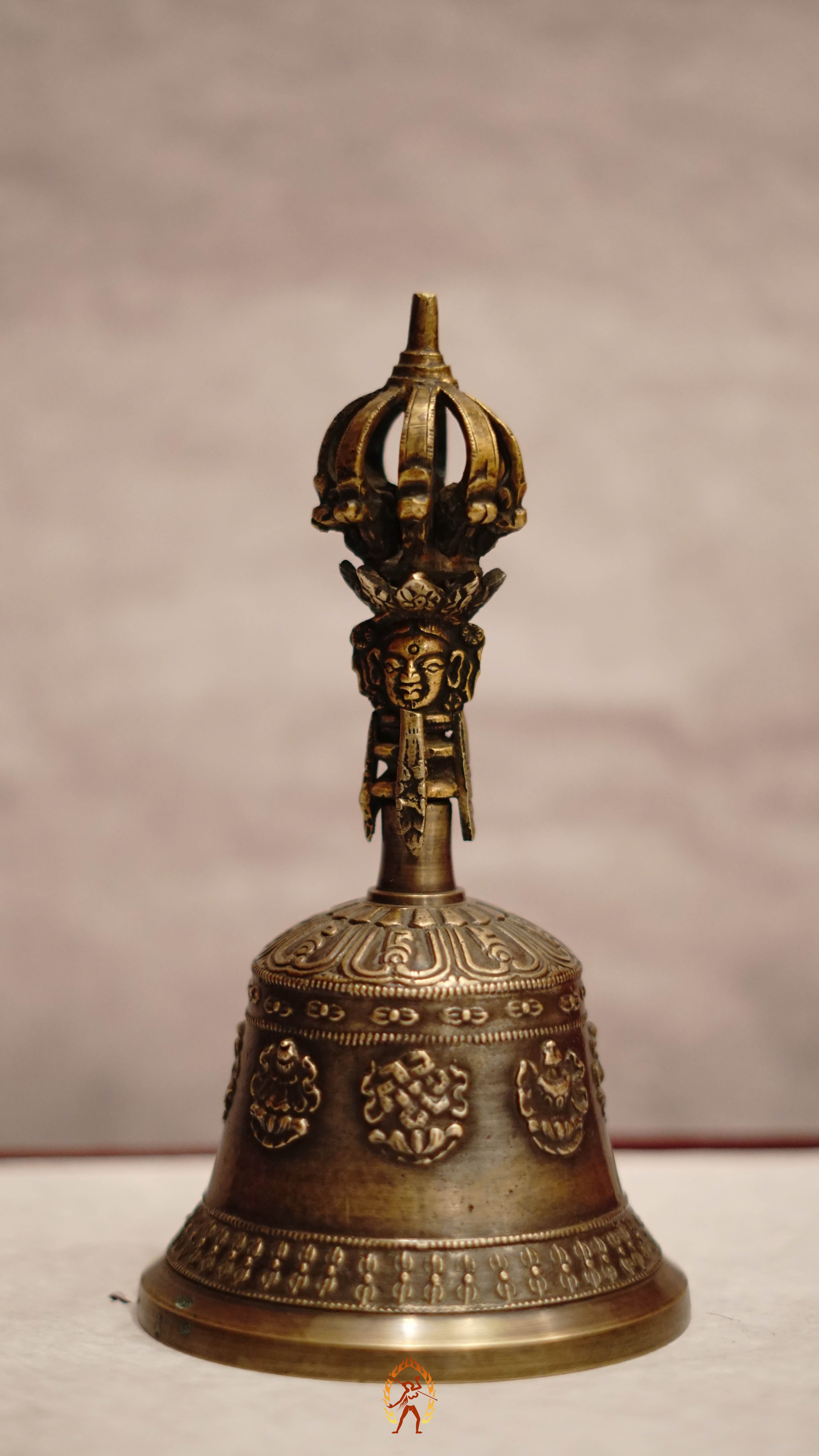 Astamangala bell featuring the Eight Auspicious Symbols and produces a clear, resonant tone ideal for puja and meditation.