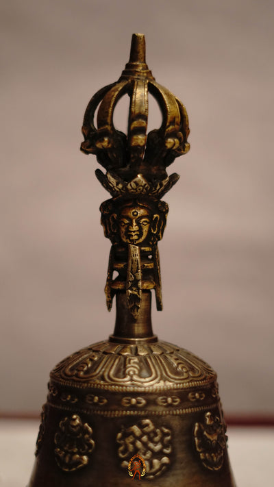 Astamangala bell featuring the Eight Auspicious Symbols and produces a clear, resonant tone ideal for puja and meditation.
