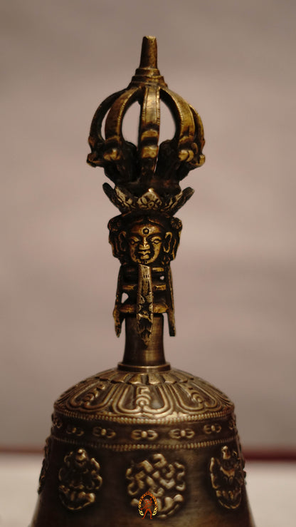 Astamangala bell featuring the Eight Auspicious Symbols and produces a clear, resonant tone ideal for puja and meditation.