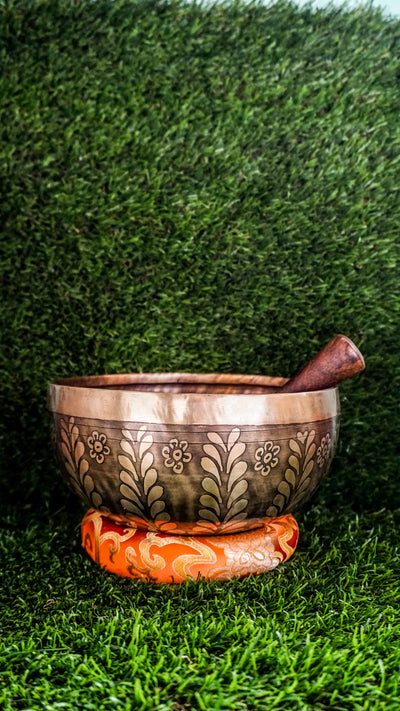The Tree Singing Bowl features a graceful tree symbol at its center, representing growth, balance, and grounded strength. Floral patterns on the outside add calm and beauty. Its deep and soothing sound supports relaxation, focus, and connection, making it ideal for meditation or creating a peaceful space.