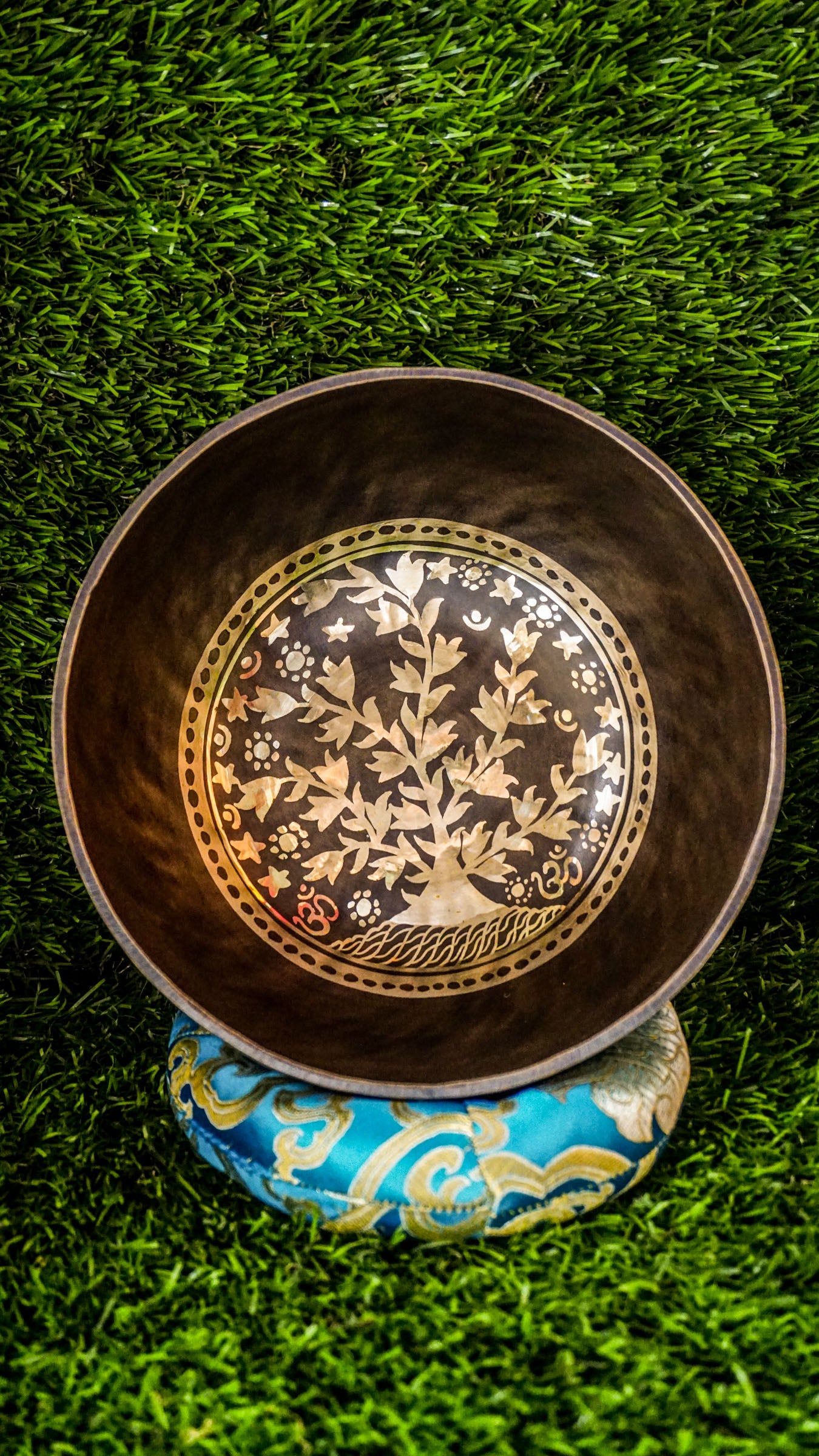 The Tree of Life Singing Bowl offers grounding and calm through sound and symbolism. At its center is the Tree of Life, representing growth and connection. Delicate floral patterns surround the design inside and out, adding natural beauty. Its warm, steady tone encourages balance, reflection, and inner peace.