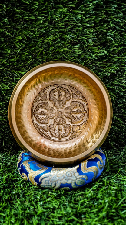 
The Dotted Vajra Singing Bowl brings steady, grounding energy to your space. Inside rests the Vajra symbol, representing spiritual power, truth, and balance between compassion and wisdom. The bowl’s subtle dotted texture keeps the design natural and simple, letting its clear, calming tones shine. Perfect for meditation or intention setting, it offers quiet strength and helps you reset and realign with ease.