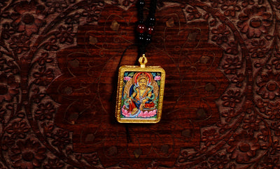 Hand-painted Yellow Zambala miniature Thangka pendant in gold-accented copper Ghau locket with black beaded cord.