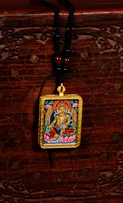 Hand-painted Yellow Zambala miniature Thangka pendant in gold-accented copper Ghau locket with black beaded cord.