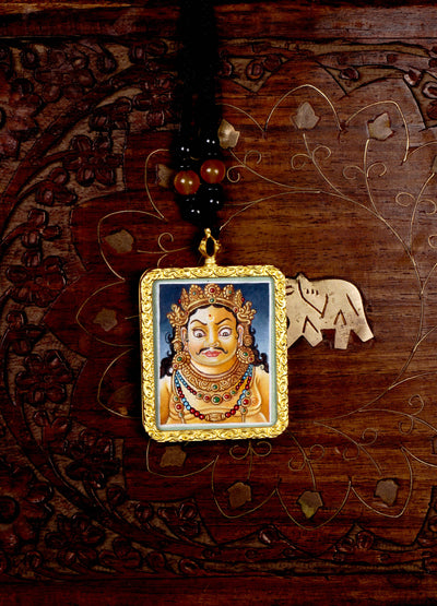 Hand-painted Zambala portrait miniature Thangka pendant in gold-accented copper Ghau locket with black beaded cord.