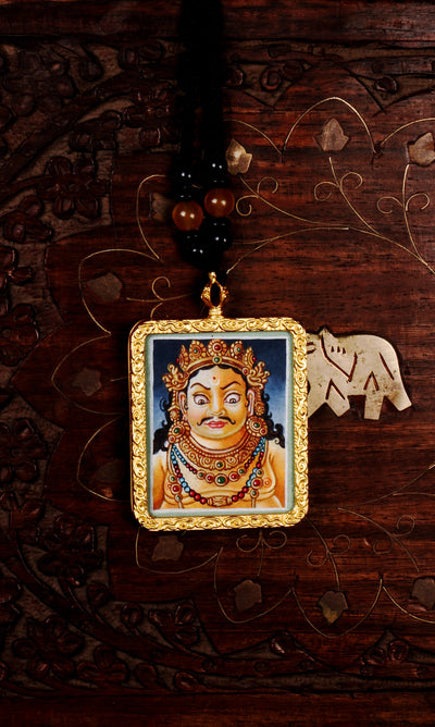 Hand-painted Zambala portrait miniature Thangka pendant in gold-accented copper Ghau locket with black beaded cord.