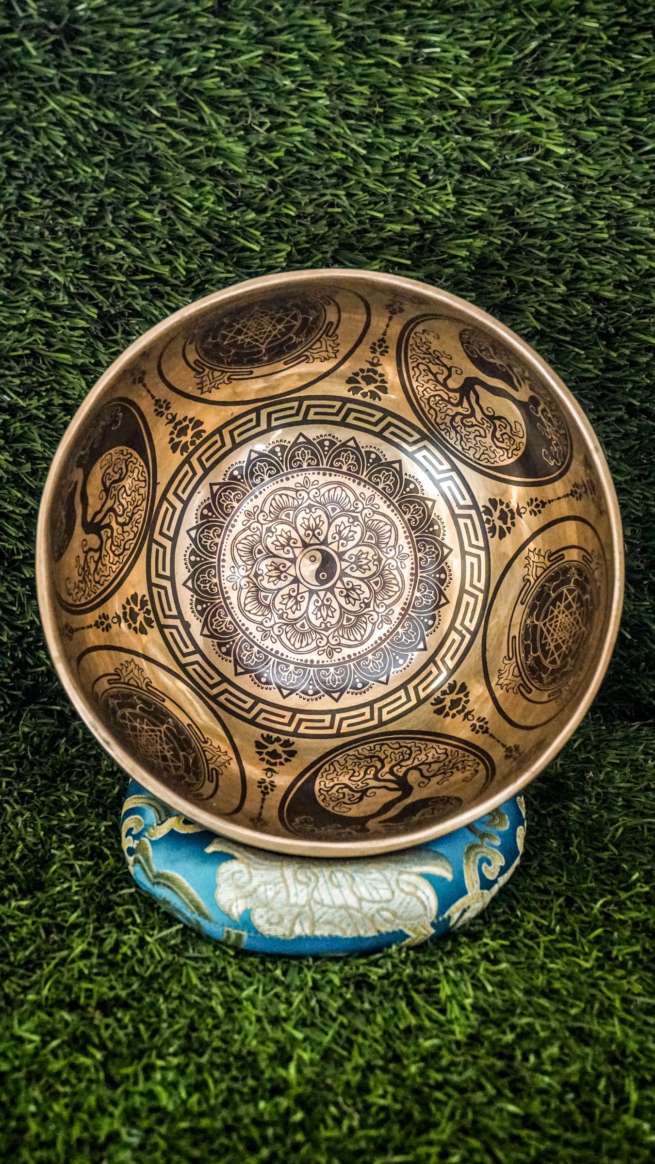 Handcrafted Yin Yang singing bowl with engraved Yin Yang symbol inside and flowing linework outside; includes wooden mallet and silk cushion, producing calming tones for balance, harmony, and meditation.