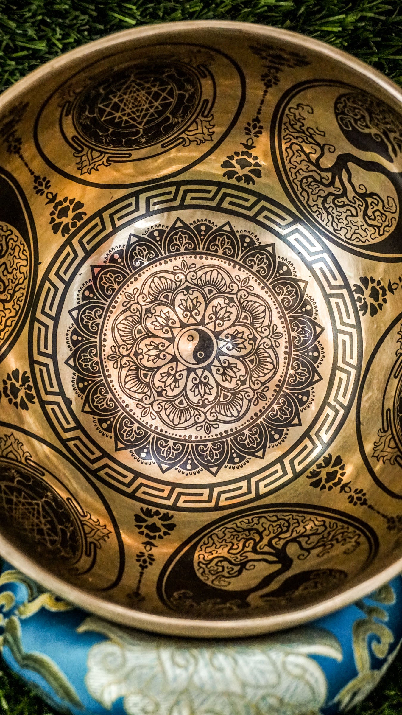 Handcrafted Yin Yang singing bowl with engraved Yin Yang symbol inside and flowing linework outside; includes wooden mallet and silk cushion, producing calming tones for balance, harmony, and meditation.