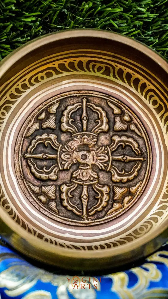 Singing bowl featuring the sacred Vajra symbol at its center, symbolizing spiritual strength and transformation, with the Om Mani Padme Hum mantra engraved around the outside, offering a calming and focused energy.